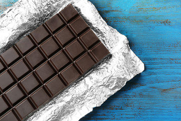 Dark Chocolate bar in foil  on gray background