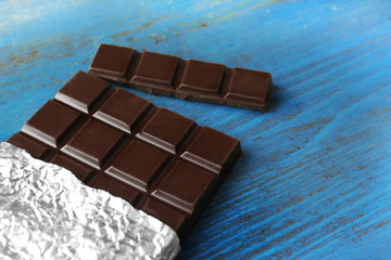 Dark Chocolate bar in foil  on gray background