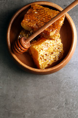 Honeycombs on plate on gray background