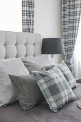 pillows on classic bed with black lamp
