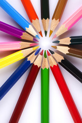Naklejka premium coloring pencils in a circle centered to the right top view shot on a white background 