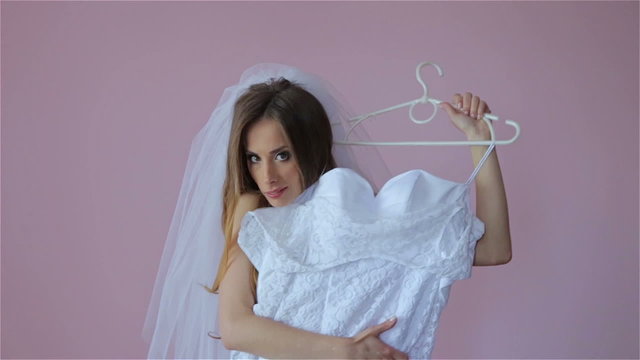 Beautiful bride tries on a wedding dress