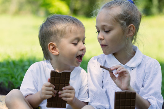 Brother and sister having fun eating chocolate