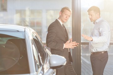 Automobile buyer discussing with seller