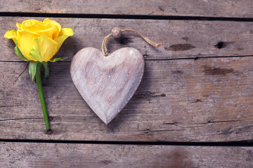 Background with  beautiful yellow rose and decorative heart