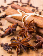 Star anise, cinnamon sticks and cloves on wooden table, seasoning for cooking