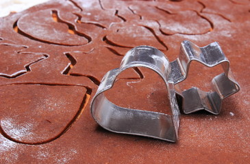 Metal cookie cutters and dough for gingerbread