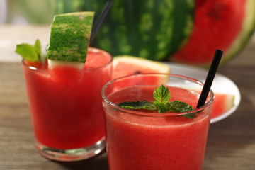 Glasses of watermelon juice on wooden table, closeup