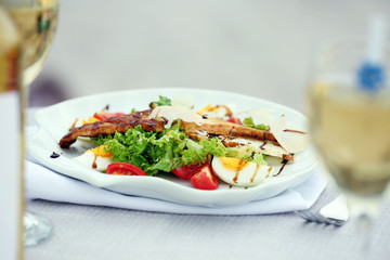 Tasty salad on white served table