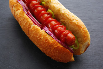 Fresh hot dog on dark grey background closeup