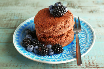 Cake with berries on wooden table
