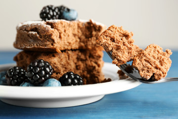 Cake with berries on wooden table