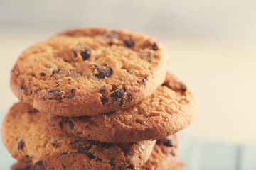 Cookies with chocolate crumbs on blue wooden table against blurred background, close up