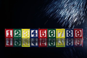 Wooden cubes with numbers isolated on black background