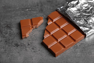 Chocolate bar in foil  on gray background