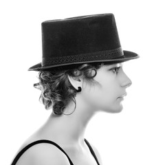 Portrait of a young woman in retro hat in profile.