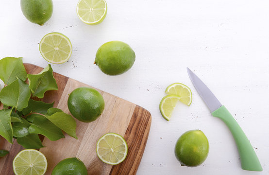 Limes on chopping board.