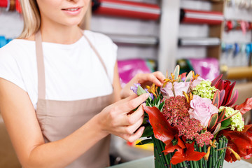 Professional florist working in a flower shop 