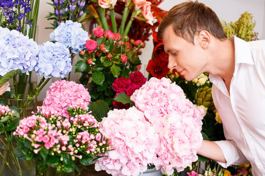Nice Man Smelling The Flowers