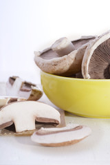 Sliced and whole fresh mushrooms.