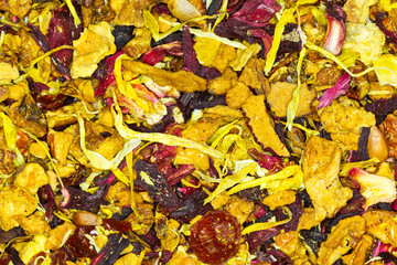 A vibrant display of Chinese herbal fruit tea, featuring a blend of exotic fruits and traditional medicinal herbs in a colorful teapot.