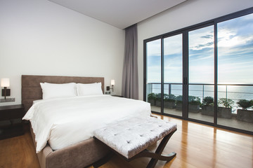 Modern comfortable, nicely decorated bedroom with seascape view