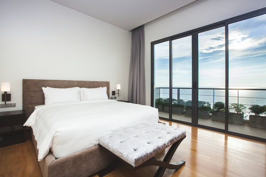 Modern comfortable, nicely decorated bedroom with seascape view