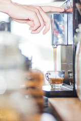 prepares espresso in coffee shop