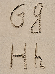 Sand font or letter set or collection on an exotic beach near the sea in summer