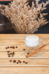Coffee cup and beans on wood pallet and gypsophila background
