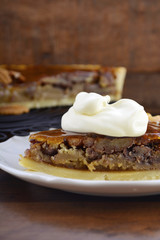 Pecan pie on dark wood background.