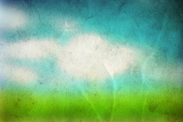 Conceptual green grass and sky old paper