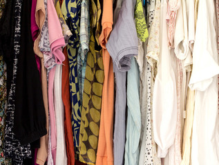 Many colorful clothes in wardrobe