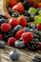 Raspberries, strawberries, blackberries and blueberries scatteri