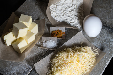 Ingredients for baking on pergament paper on grey stone table li