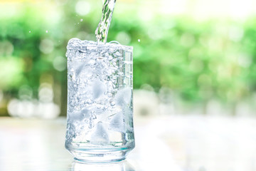 the glass of cool water with some water flow down motion