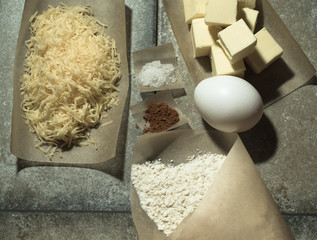 Ingredients for baking on pergament paper on grey stone table li
