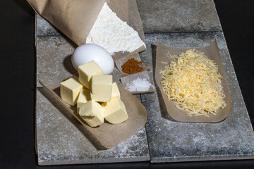 Ingredients for baking on pergament paper on grey stone table li