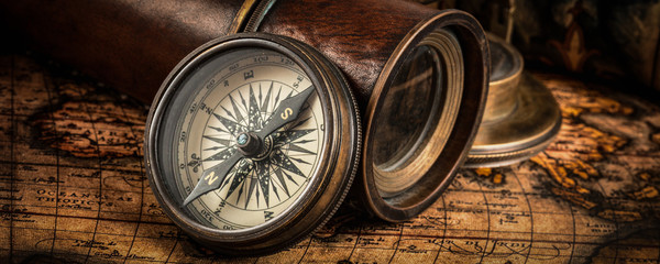 Fototapeta na wymiar Old vintage compass on ancient map