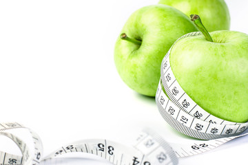 green apple with Measuring tape on diet concept 