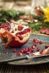 Pomegranate on rustic wooden table 