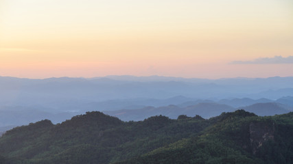 Naklejka na ściany i meble Sunset sky and misty layer mountain in sri nan national park thailand