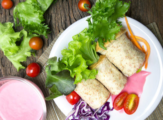fresh whole wheat bread wraps with vegetables and fruit on the p