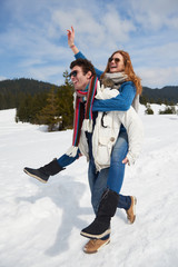 happy young couple having fun on fresh show on winter vacation