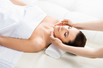 Fototapeta na wymiar Beautiful woman laying on a mat in massage salon.
