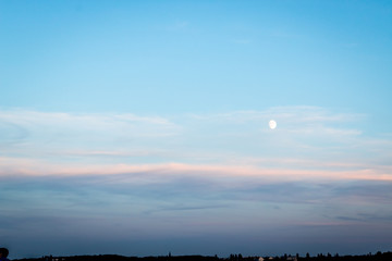 City sunset with the moon