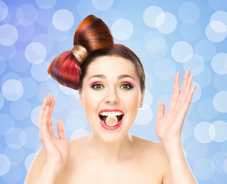 Attractive Excited Girl With Colored Hair Having Candy In Mouth On Bubbly Background.