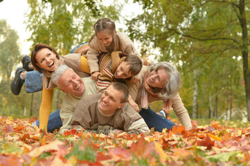 Family relaxing in autumn park