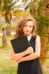 beautiful teenager on campus with her folder of notes