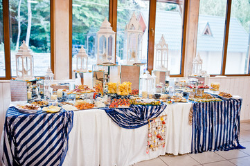 sea table of meat, cheese and snacks on wedding reception